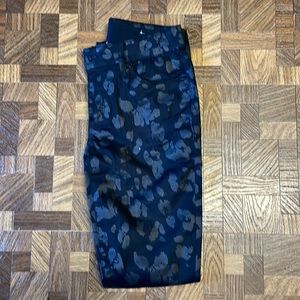 Women Chico’s brand animal print black matte on black jeans.